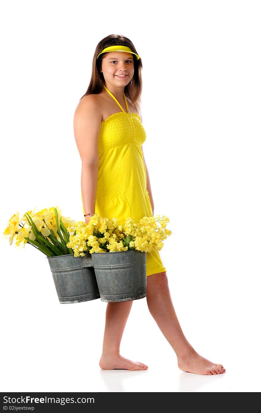 An attractive young teen in a bright yellow sundress carrying a double-bucket full of yellow spring flowers. Isolated on white. An attractive young teen in a bright yellow sundress carrying a double-bucket full of yellow spring flowers. Isolated on white.