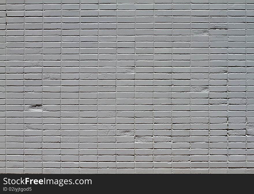 Close-up of a brick wall that has been painted gray from distance. Close-up of a brick wall that has been painted gray from distance