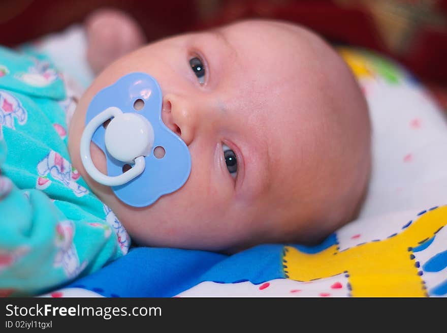 Photo of the beautiful baby lying on bed