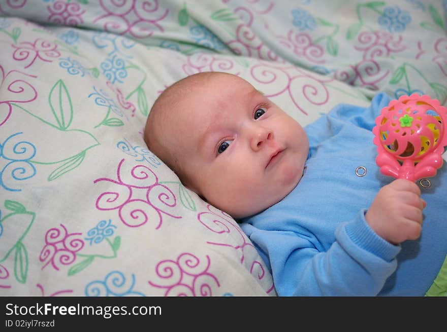 Photo of the beautiful baby lying on bed