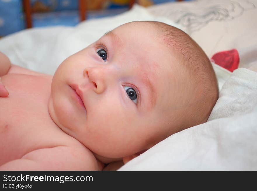 Photo of the beautiful baby lying on bed