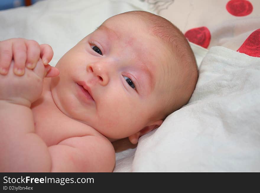 Photo of the beautiful baby lying on bed