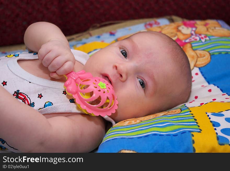 Photo of the beautiful baby lying on bed