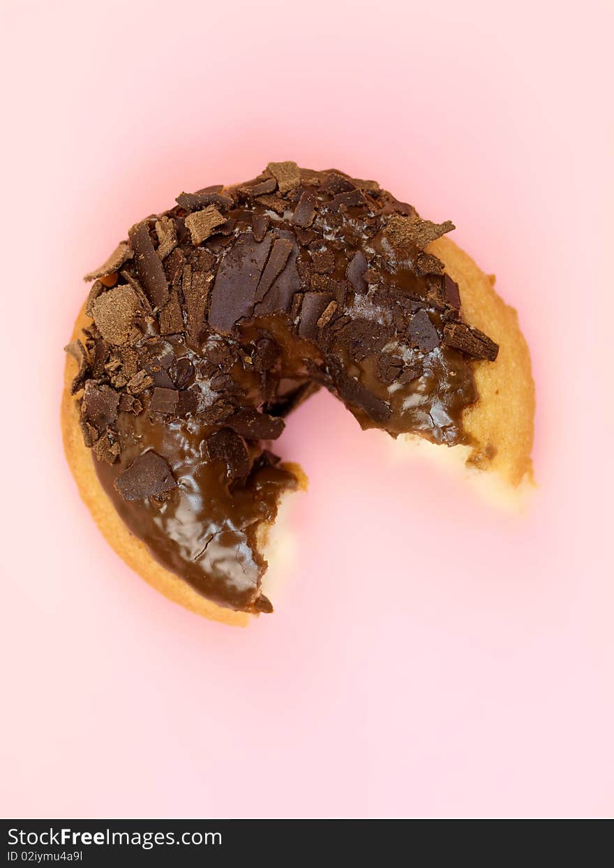 Chocolate donuts in a plate isolated against a pink background