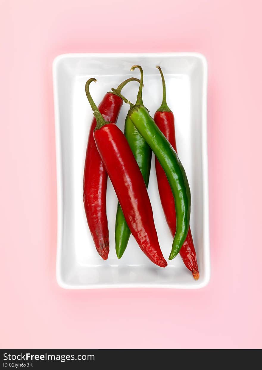 Chilli Peppers isolated on a pink background