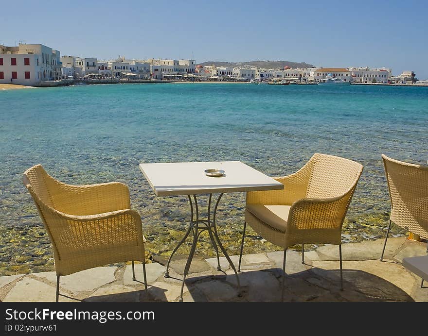 Wicker chairs in cafeteria near the sea on island