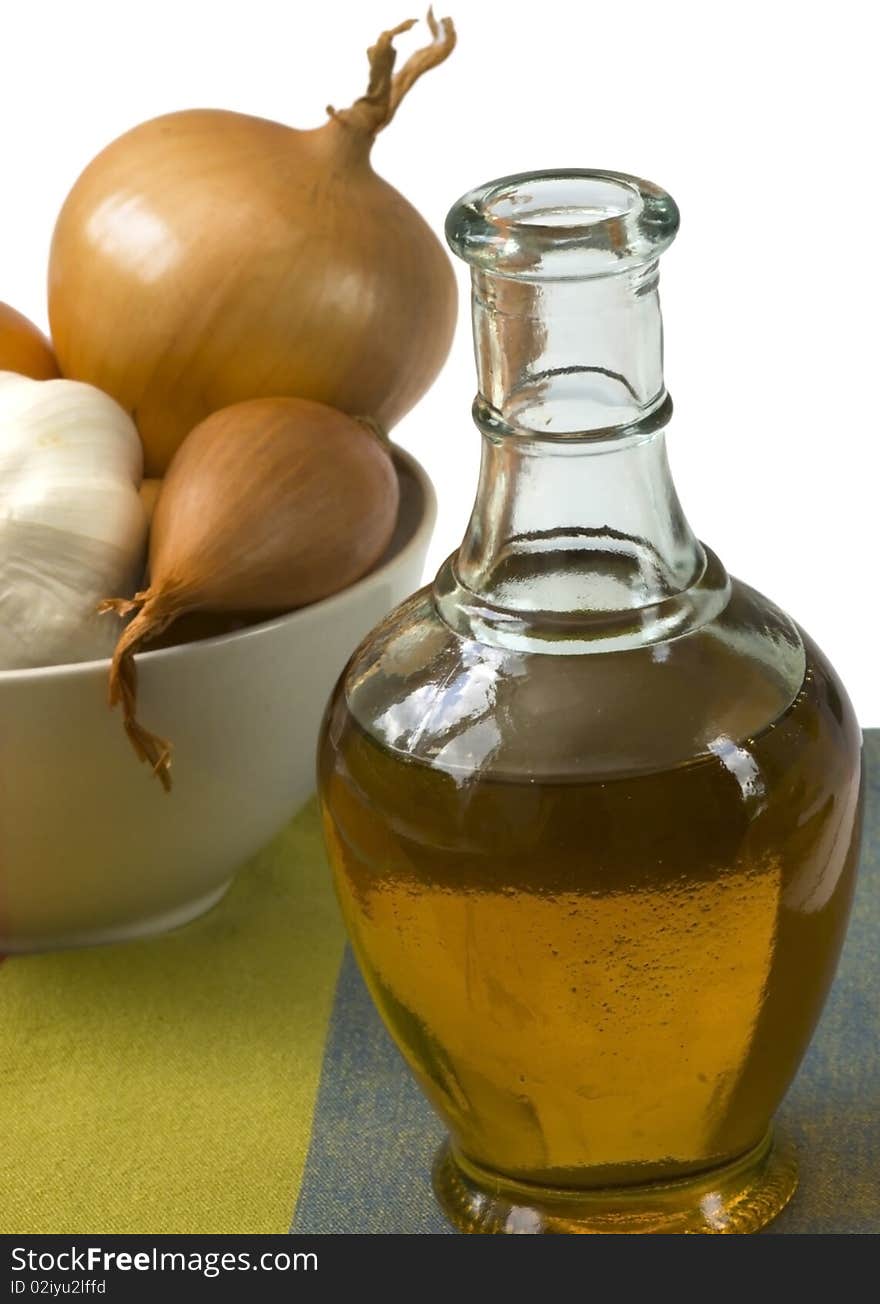 Bottle of olive oil with onion and garlic