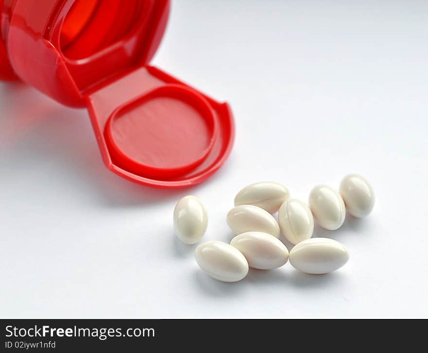 Close up of red medicine bottle with capsules. Close up of red medicine bottle with capsules