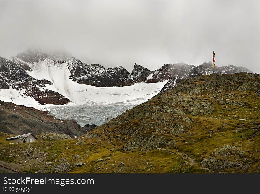 An area high in the Swiss alps with a hut and hiking trails. An area high in the Swiss alps with a hut and hiking trails.