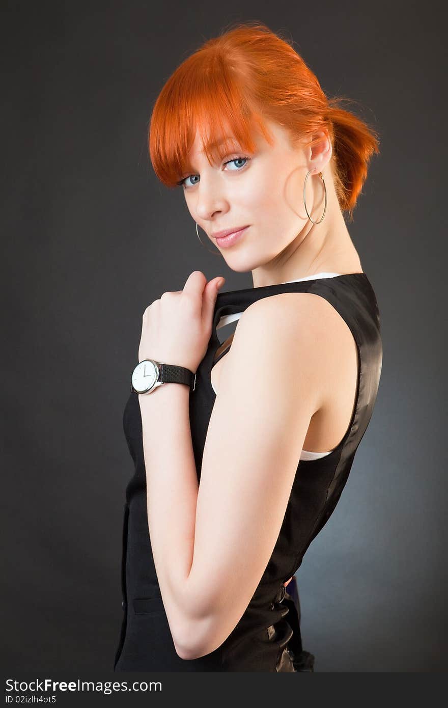 Beautiful red girl against a dark background. Beautiful red girl against a dark background