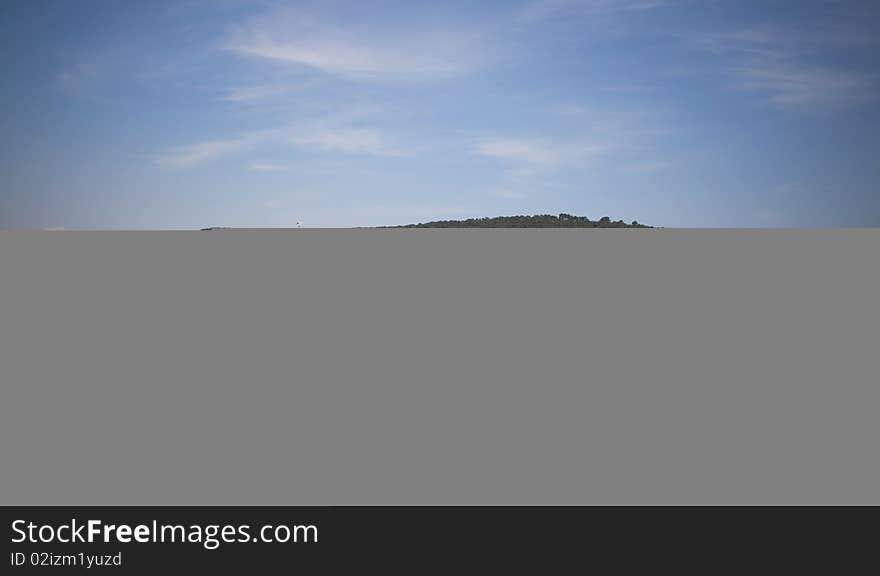 Man sitting on rocks in the ocean. Man sitting on rocks in the ocean