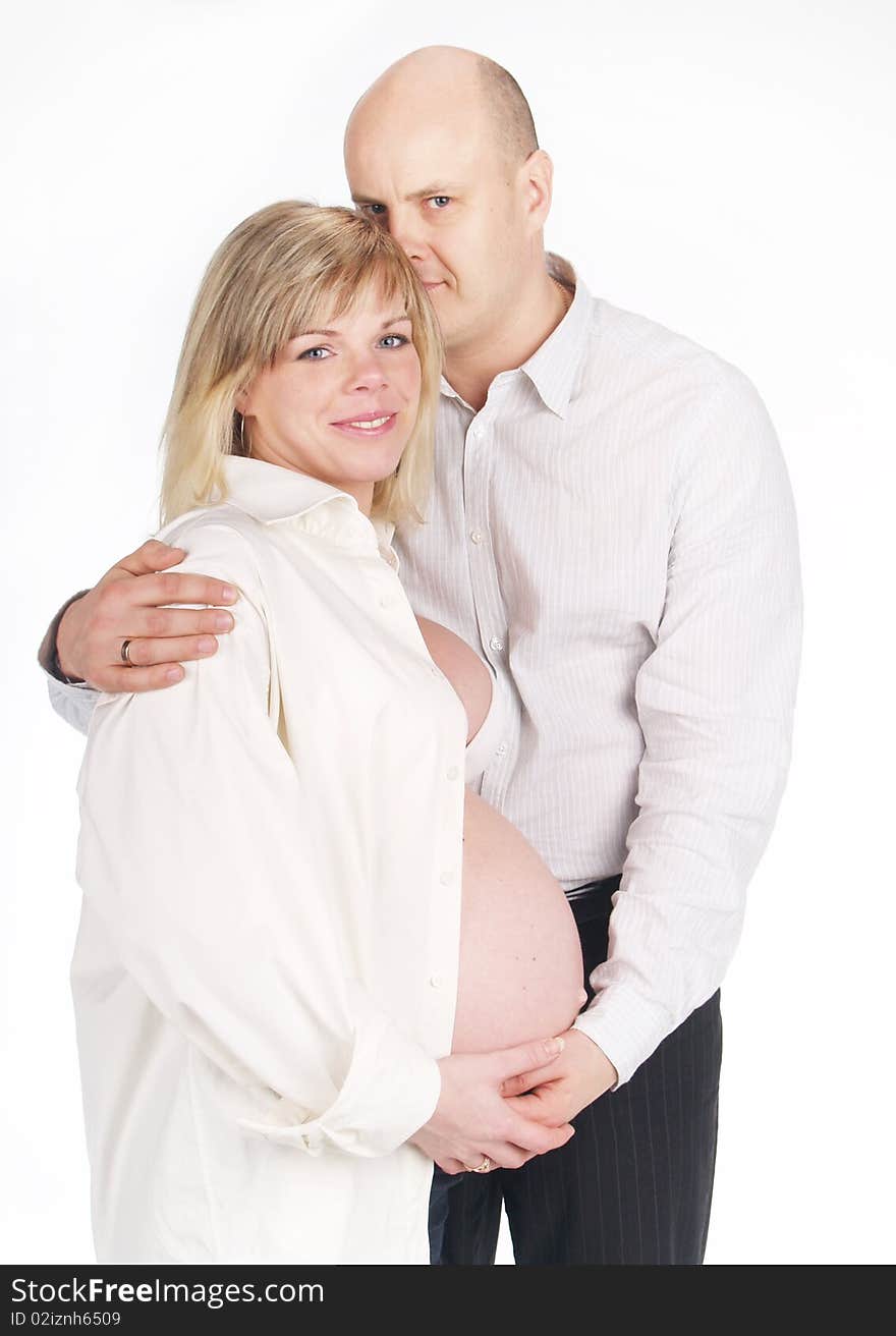 Pregnant woman poses with her husband . Not a young pair. Pregnant woman poses with her husband . Not a young pair