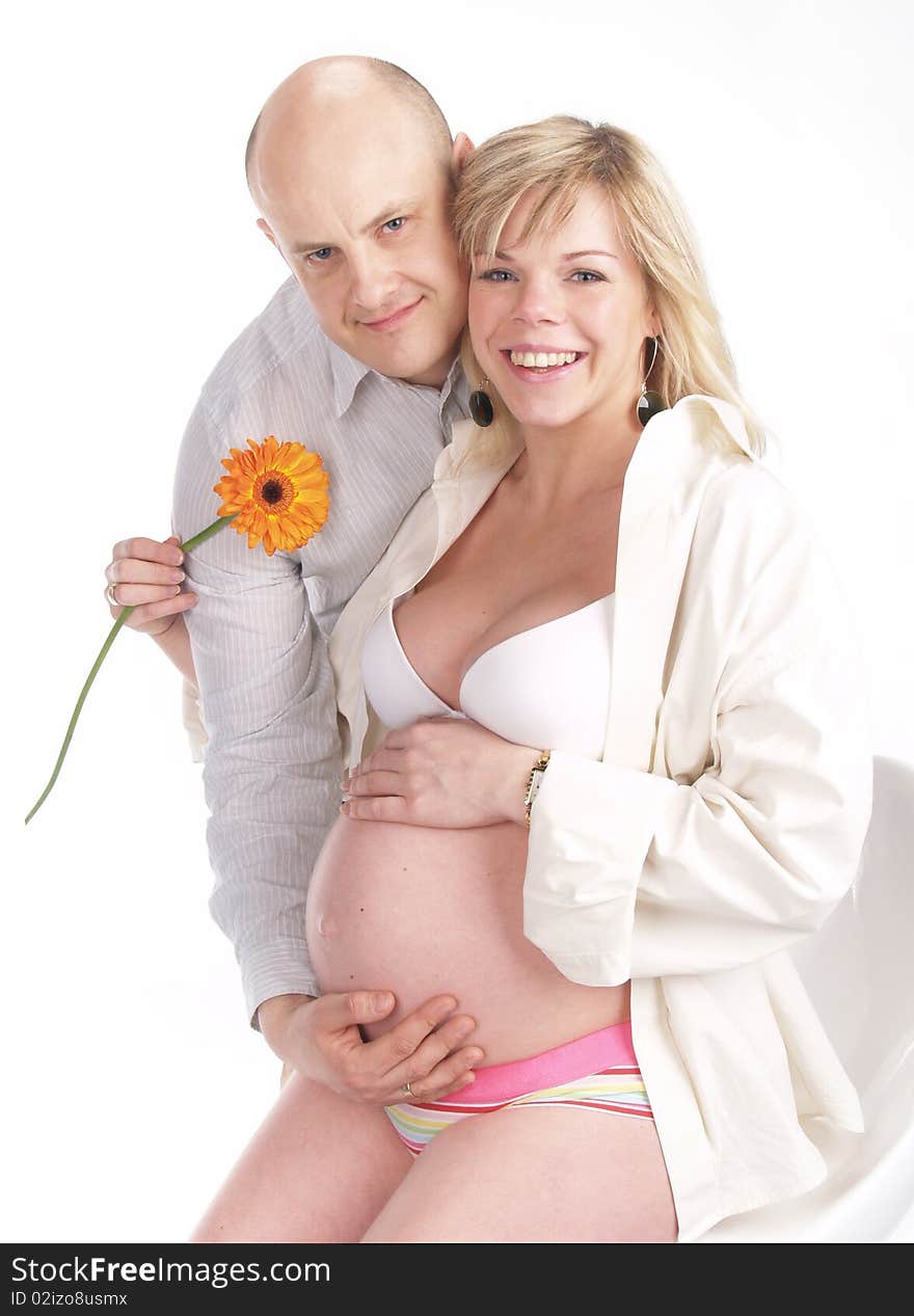 Pregnant woman poses with her husband. Not a young pair. Pregnant woman poses with her husband. Not a young pair