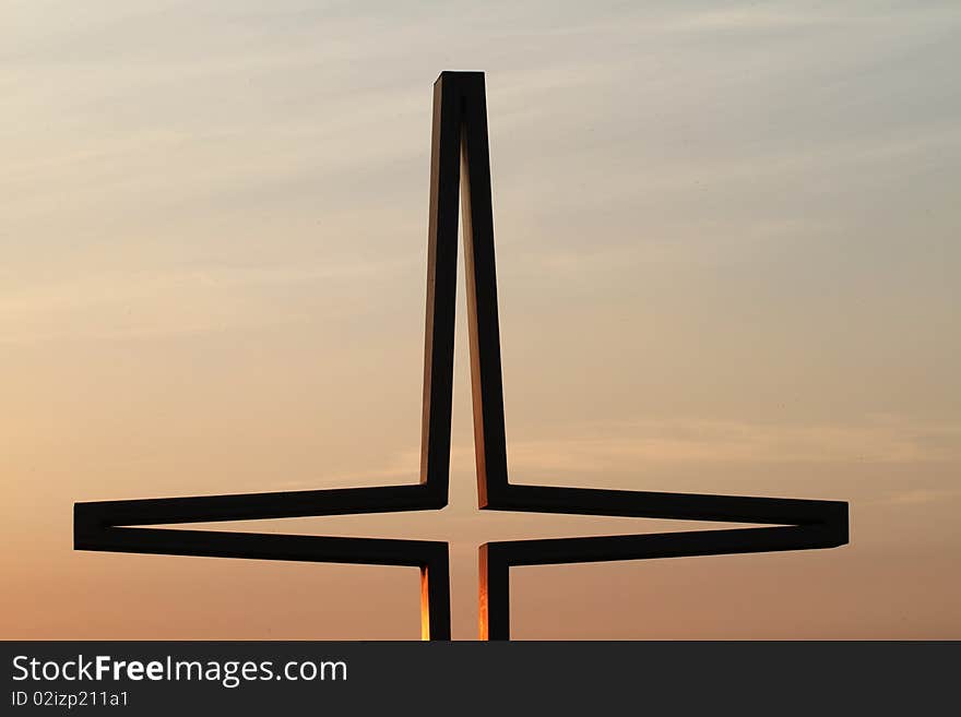 Cross in sky in sunset light