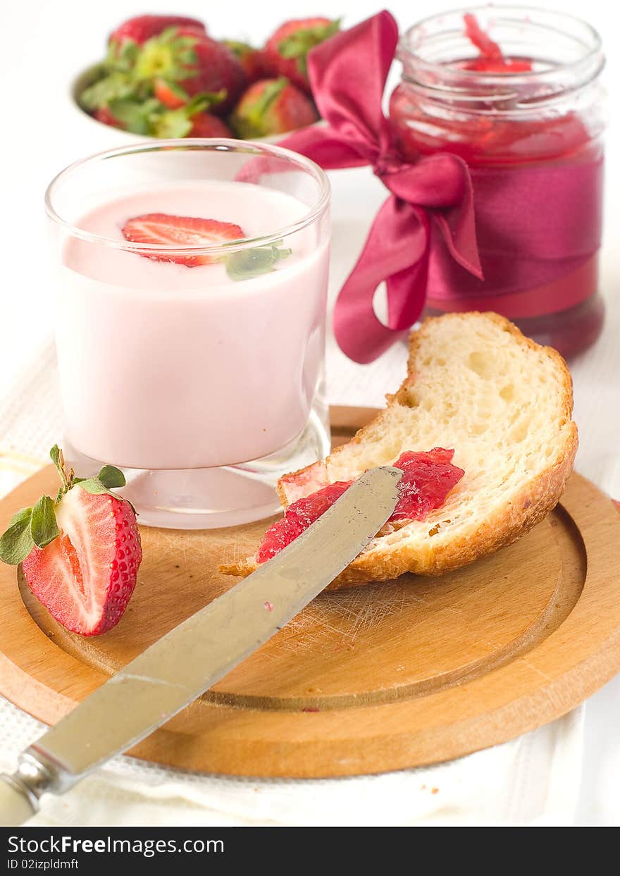 Strawberry yogurt with fresh strawberry and croissant with strawberry jam for breakfast