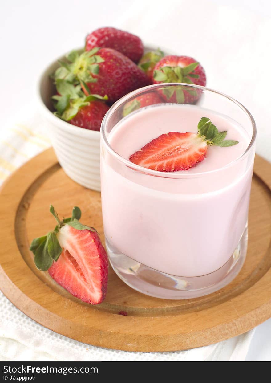 Strawberry yoghurt with  fresh strawberry. On  background a bowl with  strawberry