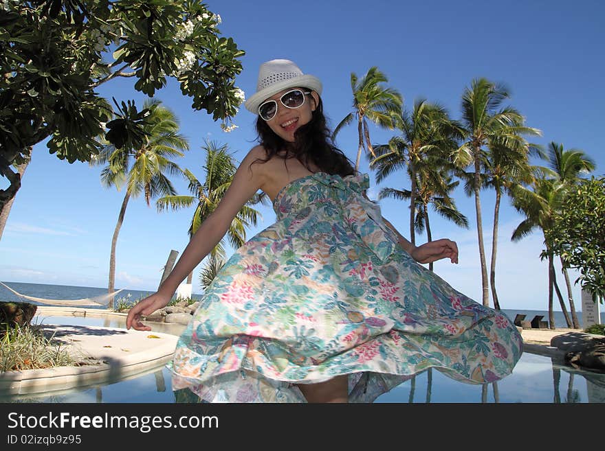 An Asian girl posting at tropical luxurious resort in Fiji, South Pacific Ocean. An Asian girl posting at tropical luxurious resort in Fiji, South Pacific Ocean