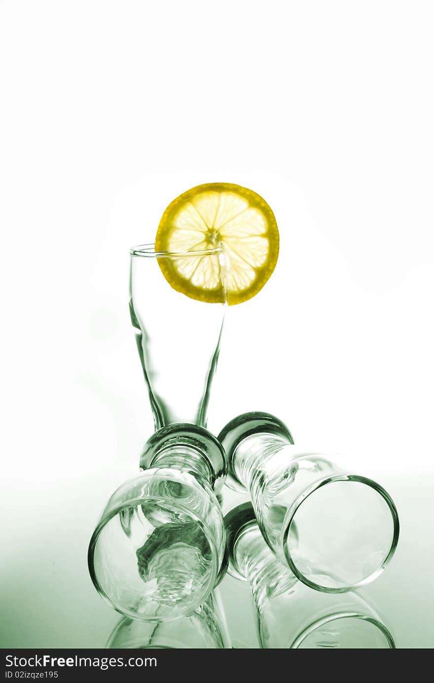 Beautiful glasses and lemon on white background