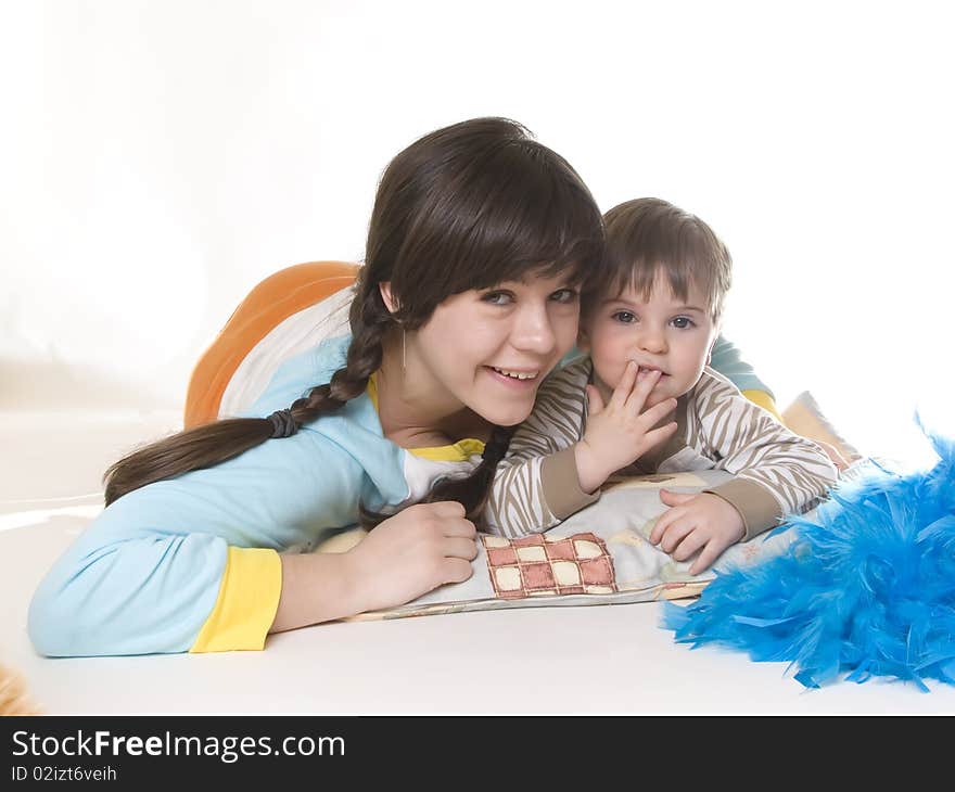 Young girl and small boy lying together in hug. Young girl and small boy lying together in hug