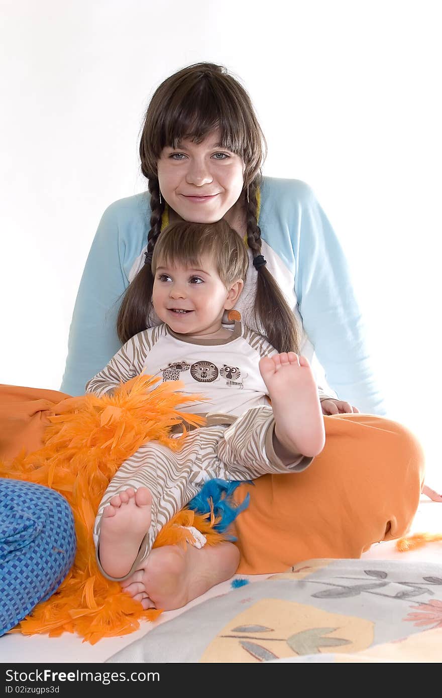 Young girl and small boy sitting together on white backgound. Young girl and small boy sitting together on white backgound