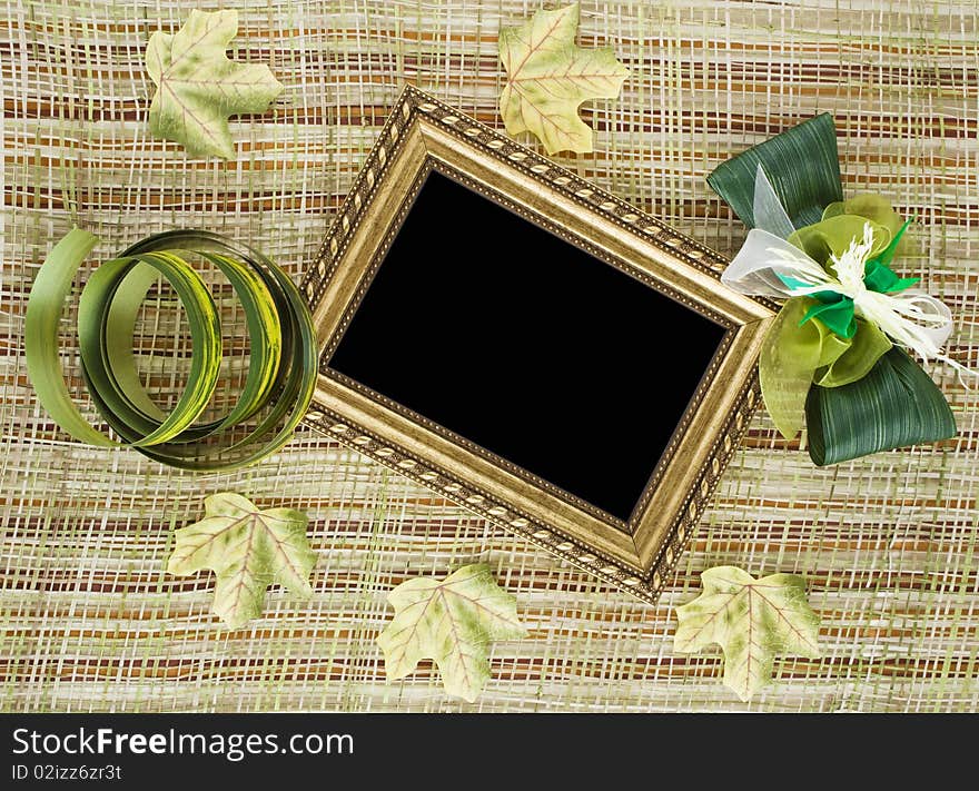 Creative background made of vintage blank frame and decorative textile leaves