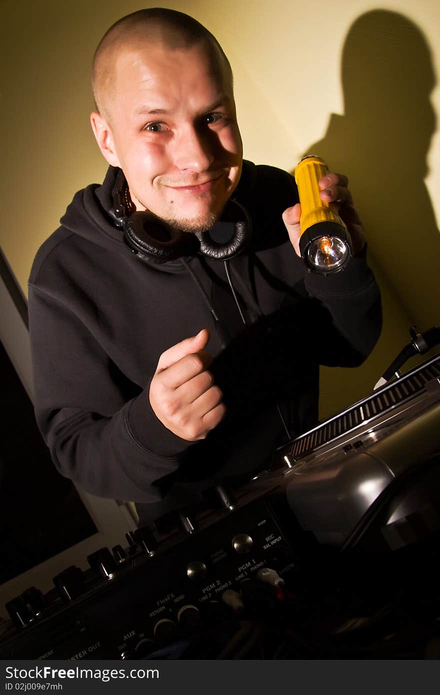 DJ with a flashlight at the turntables