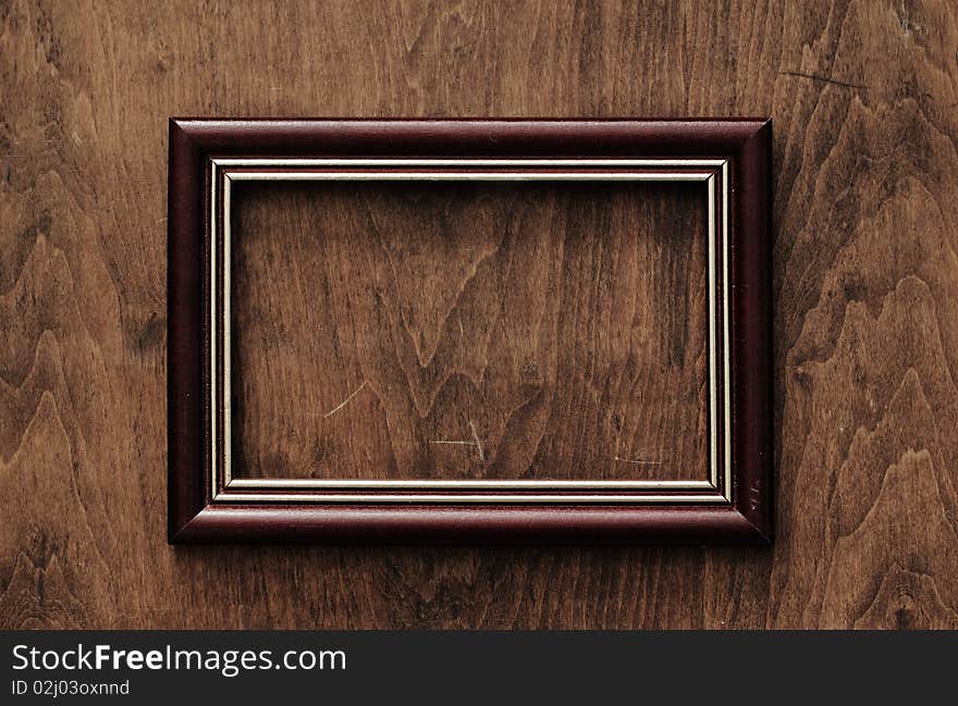 Blank frame on old wooden background