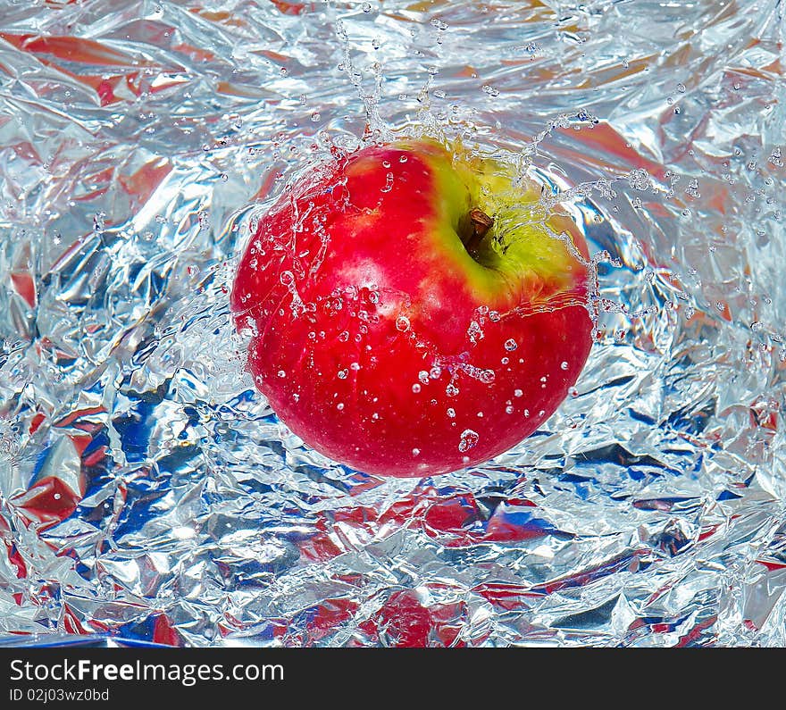 Red apples in water with a splash. Red apples in water with a splash