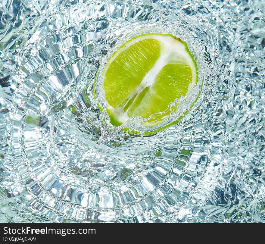 Fresh lime in water with a splash