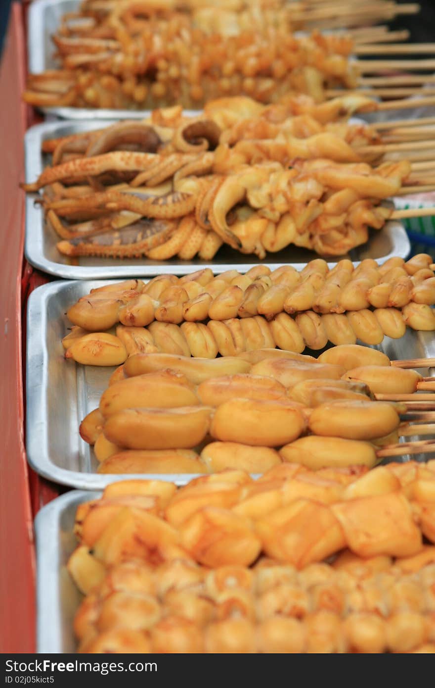 Squid on a stick ready for barbecue, Bangkok, Thailand. Squid on a stick ready for barbecue, Bangkok, Thailand.