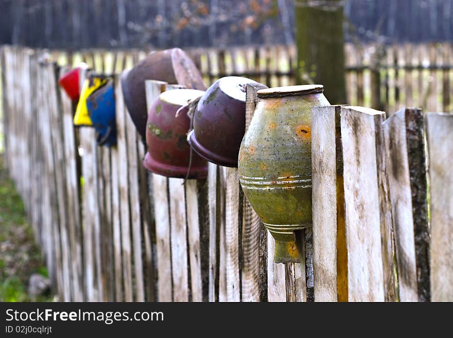 Old wooden boundary fence with nails on sunny day