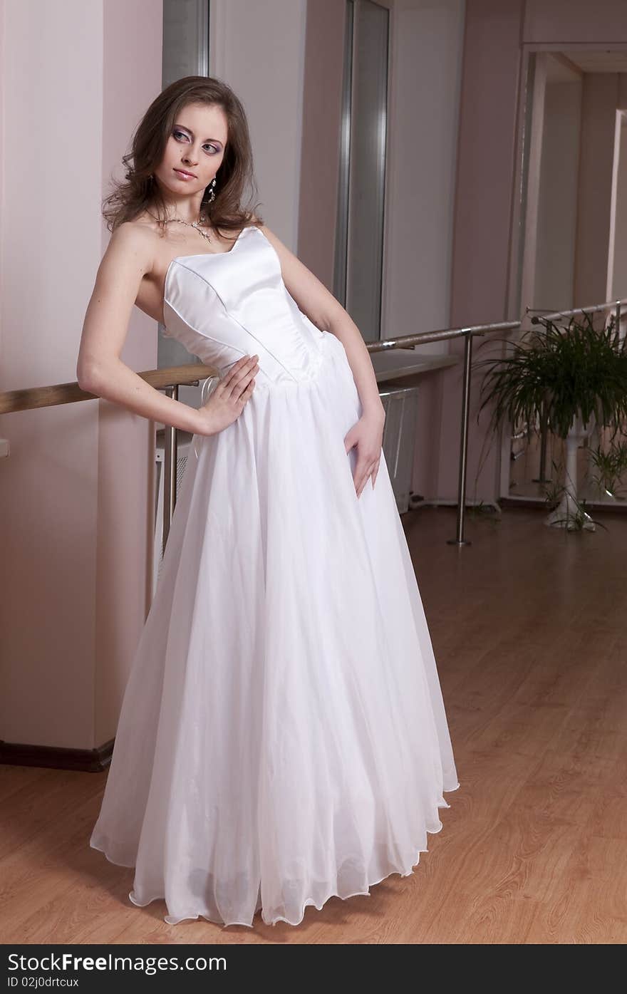 Girl in white wedding dress in dance studio. Girl in white wedding dress in dance studio