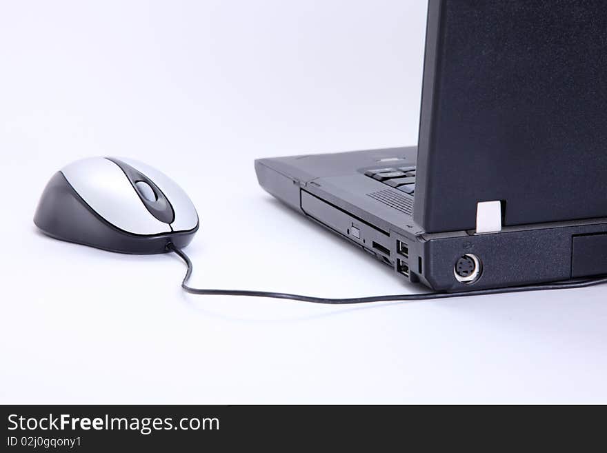 Laptop with mouse over white background. Technology image. Laptop with mouse over white background. Technology image