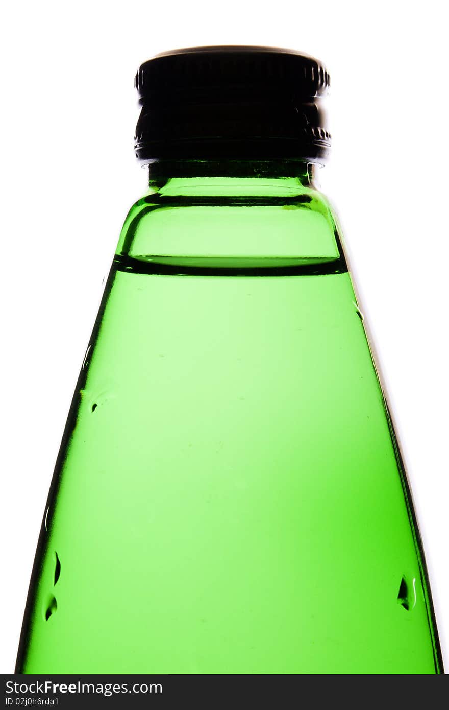 Clean mineral water in a green glass bottle it is isolated on white