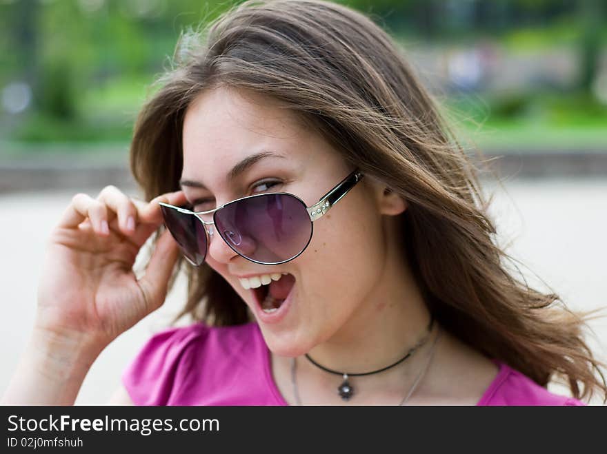 Portrait of a smiling beautiful teenage girl in sunglasses. Portrait of a smiling beautiful teenage girl in sunglasses