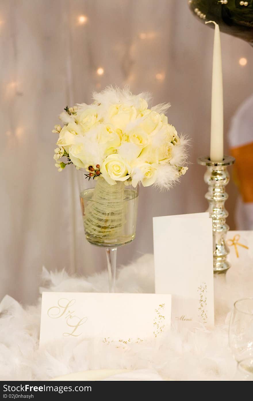 Yellow flowers and silver candle on the table. Yellow flowers and silver candle on the table