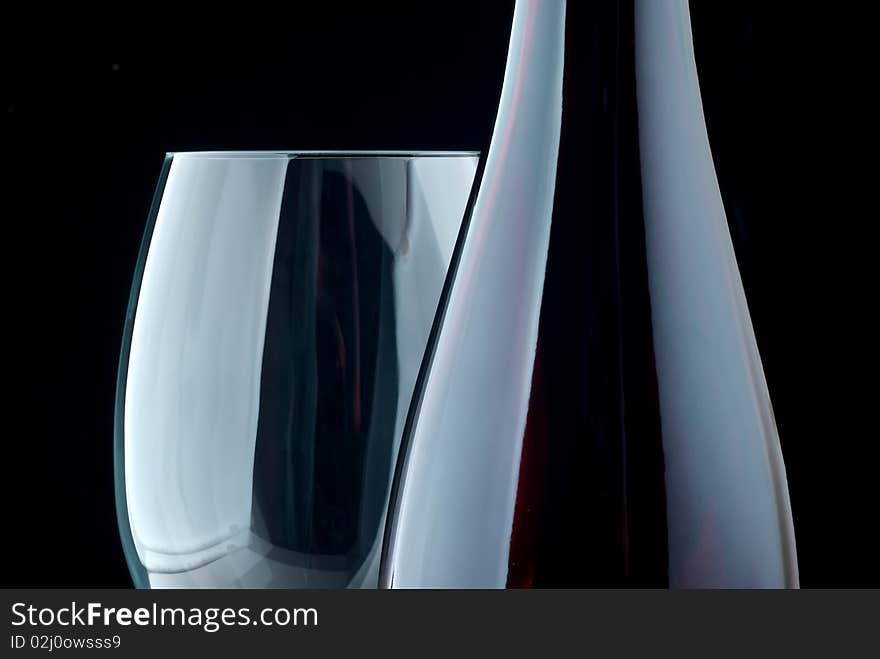 Bottle and glass on a black background. Bottle and glass on a black background