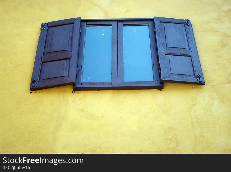 Wood door with a yellow building. Wood door with a yellow building.