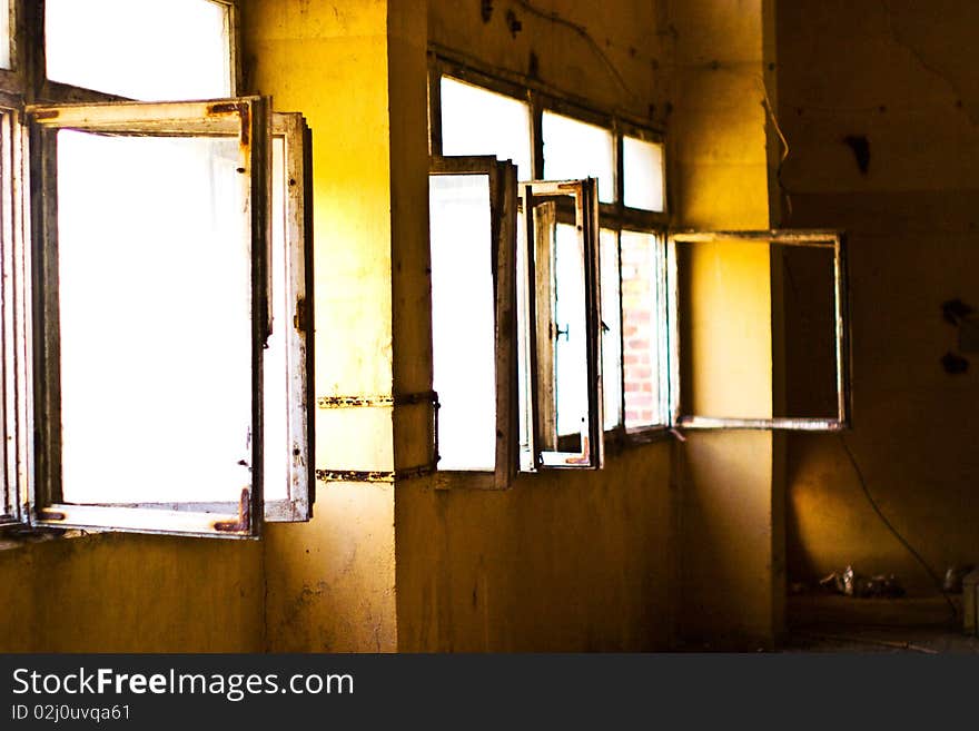 Discarded ruin with old windows and wall, industrial window in concrete wall