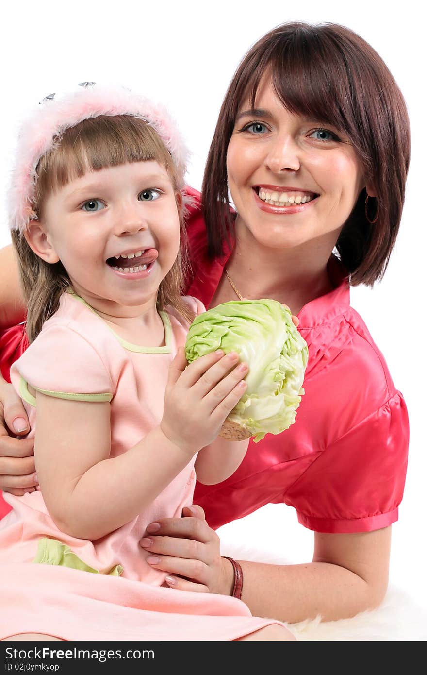 Happy family. Beautiful mother and her little daughter wants to eat cabbage. Series. Happy family. Beautiful mother and her little daughter wants to eat cabbage. Series