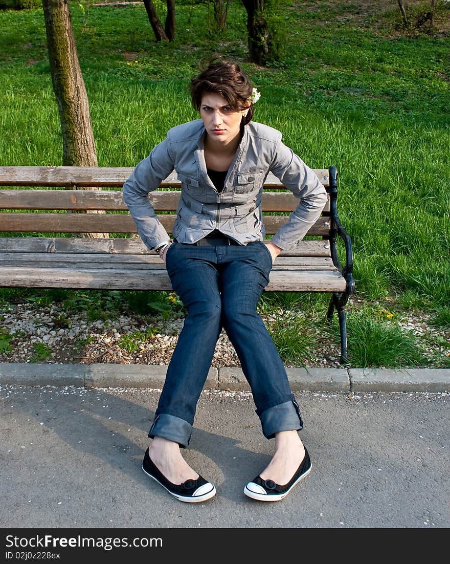 Upset girl sitting on a bench