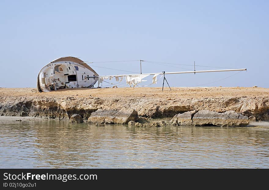 Wreckage of a sailing yacht on the shore