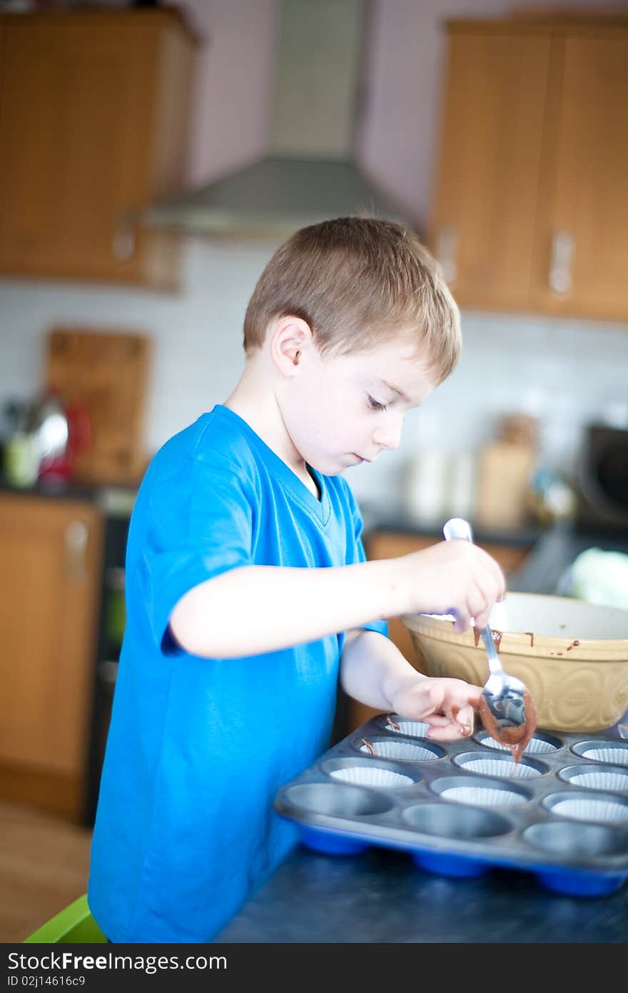 Young Boy Making Chocolate Cakes