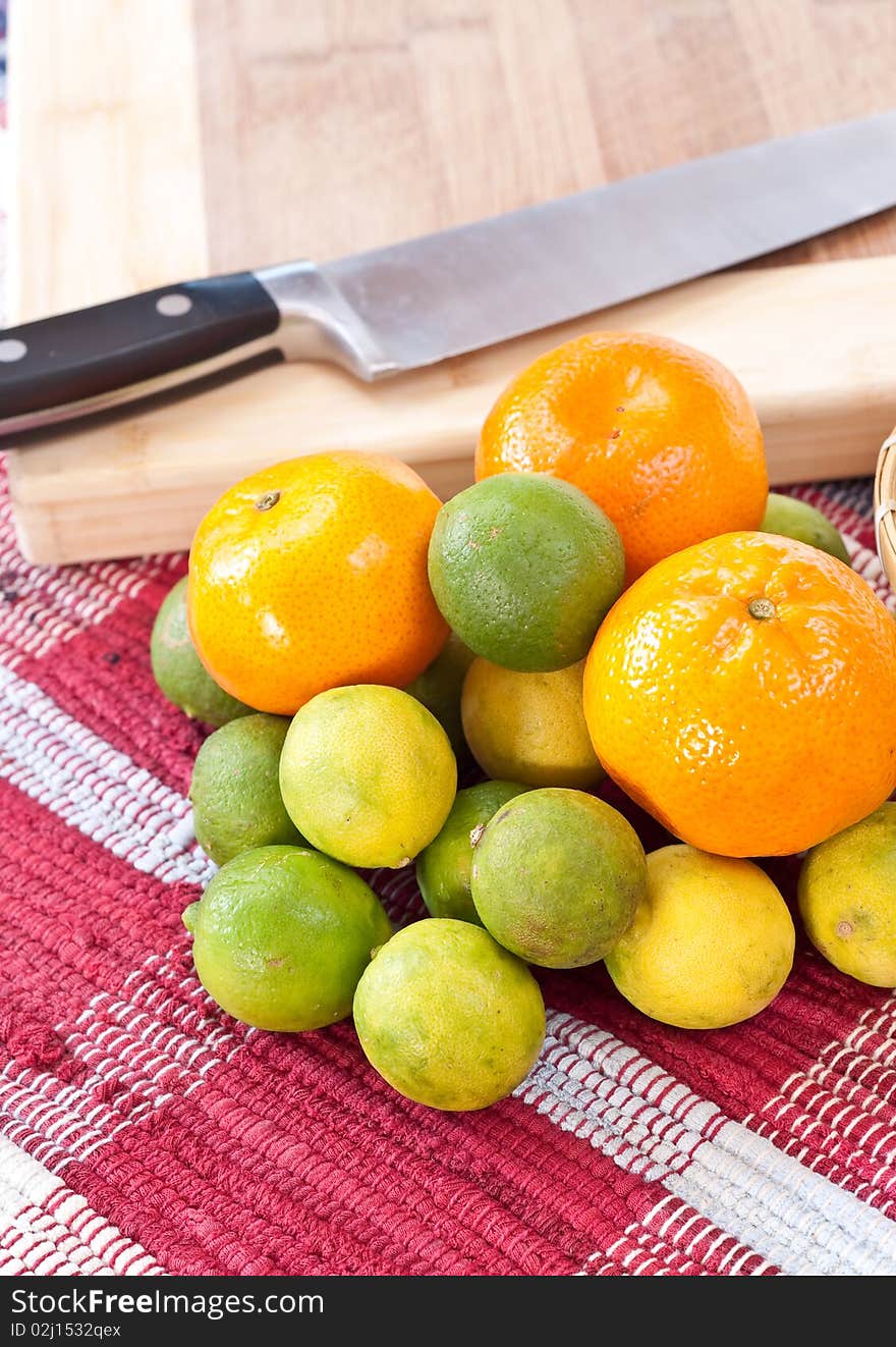 Citrus fruits in front of cutting board. Citrus fruits in front of cutting board