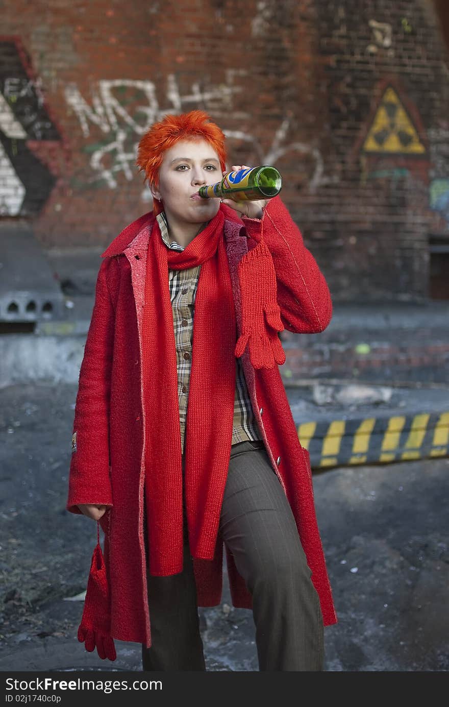 Red-haired woman is drinking beer