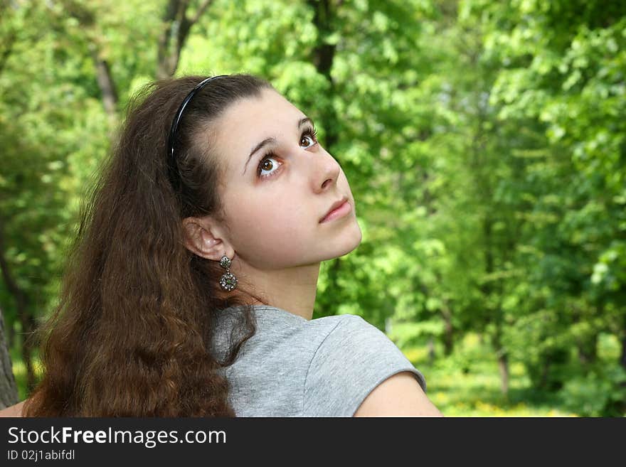 Pretty girl on the green background looking. Pretty girl on the green background looking