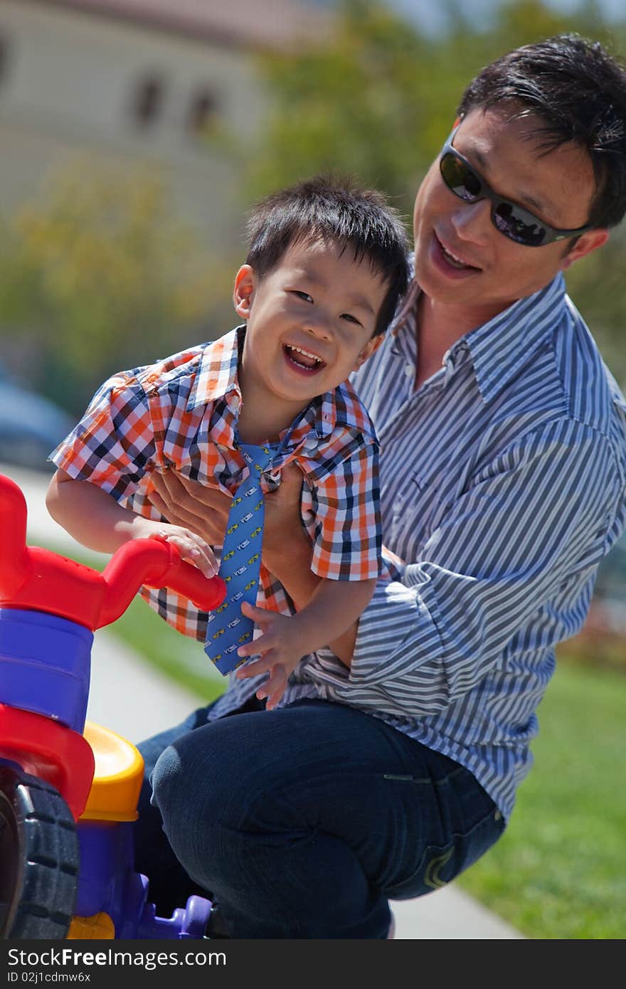 Father plays with his little son by making him fly. Father plays with his little son by making him fly