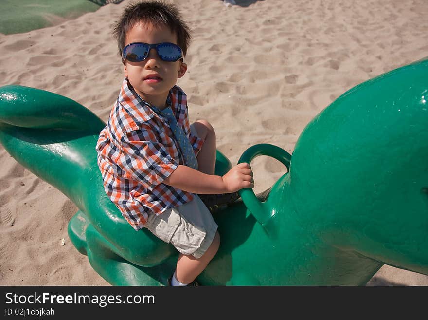 Boy riding a toy dragon