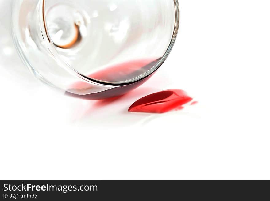 Red wine spilling from glass