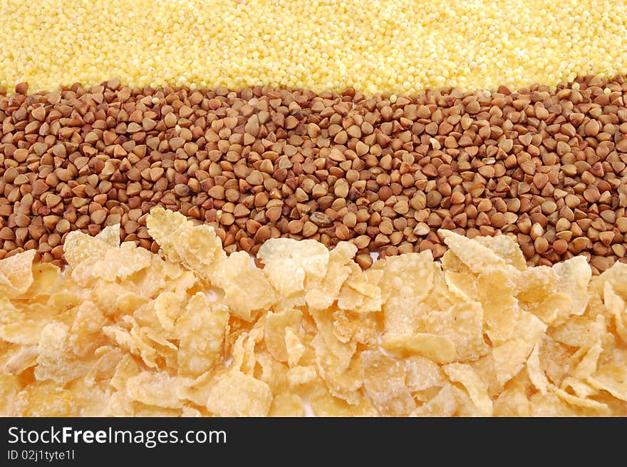 Three cereals (buckwheat, millet, corn flakes) isolated on a white background. Three cereals (buckwheat, millet, corn flakes) isolated on a white background